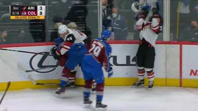 MacKinnon politely gives Garland's helmet back after a wrestling match in the corner.