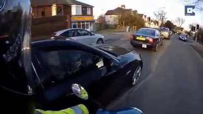 Johnny big bollocks drives past biker in black BMW way too close and starts argument,  
