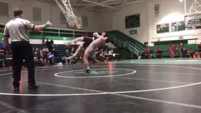 Father tackles son's opponent after illegal move during a high school wrestling match.