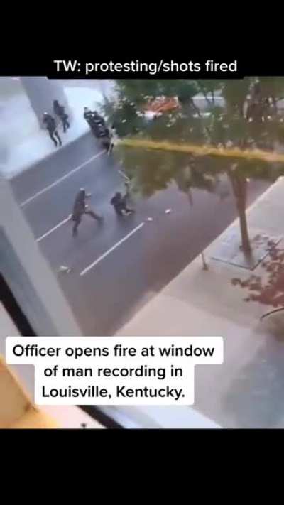 Out of nowhere officers shots a fire at the camera man nearly misses him.