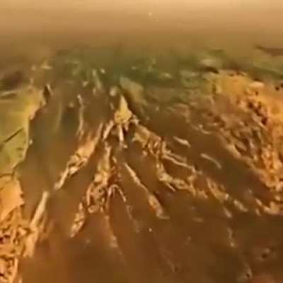 Huygens probe descending on the surface of the Titan, this landing on the Saturn's largest moon was possible because of NASA's Cassini probe..