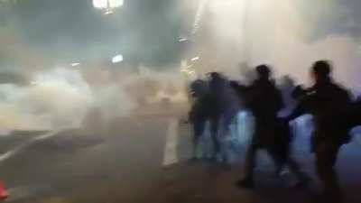 A scene straight out of a dystopian movie from the Portland protests. Federal officers advance as they shoot at and gas protestors.
