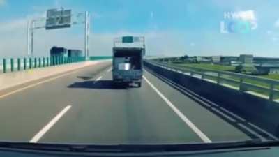 Box falls out of truck and bounces back in