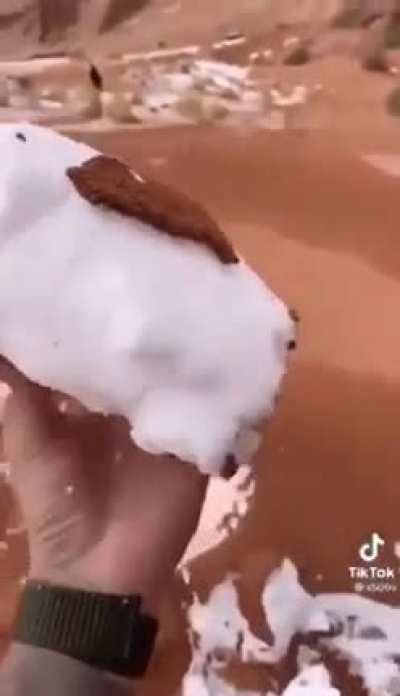 Snow fall trapped between sand layers in Saudi Arabia desert.