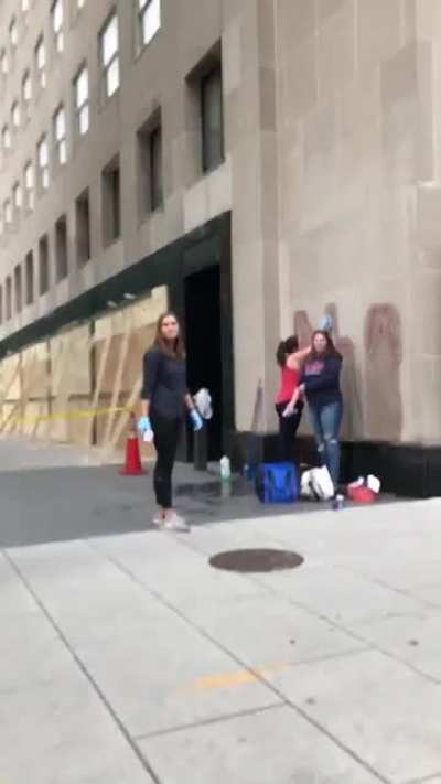 Girls cleaning a building in their city are yelled at