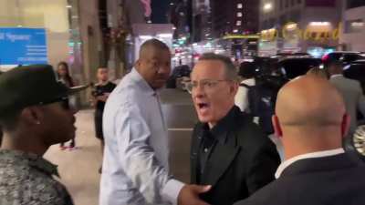 Tom Hanks rushes to protect wife Rita Wilson as an aggressive fan nearly knocks her over: 'Back the fuck off!'