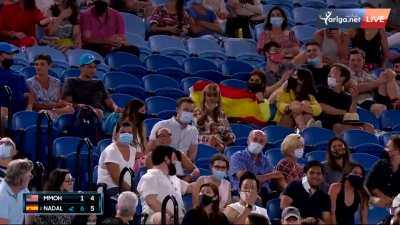 Intoxicated woman yells "Hurry up, you OCD f**k" to Rafael Nadal as he is about to serve for the second set, gesticulates as he gets through the game, and flips off the crowd as she is escorted out of the arena.