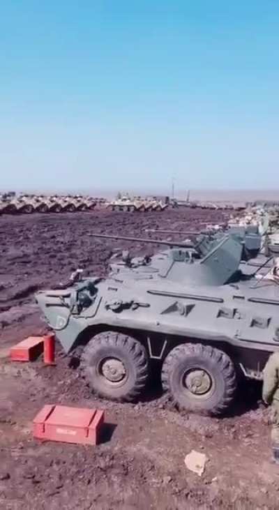 Russian BTR-82 in different colors somewhere in the field close to the border with Ukraine