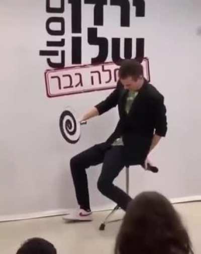 His trying to hypnotize the audience.