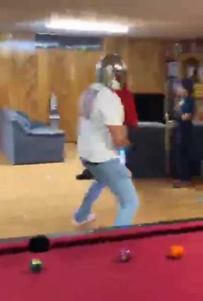Just a guy with a mandalorian helmet twerking with a rainbow lightsaber