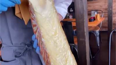Pouring melted cheese