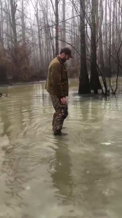Duck hunter left his gun by the tree