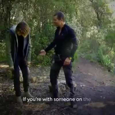 Bear Grylls shows Cara Delevingne some techniques how to poop in the woods