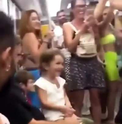 This little girl was crying on the subway so this group of guys started singing baby shark to cheer her up