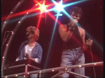 A-Ha singing "Take on Me" live on L&oslash;rdagssirkus(1984)...Upon release, the song flopped in Europe...but Warner Bros VP in London saw Morten Harket sing and said, "This kid is as beautiful as Elvis with Roy Orbison's voice." WB re-produced the song...Harket