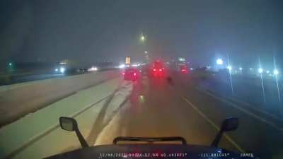 Truck carrying oil attempts to pass on the right during snowstorm