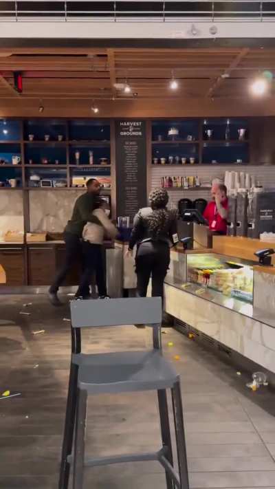 Lady fighting with employees in an airport restaurant