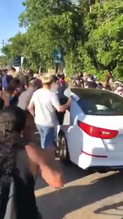 Guy at protest smashes a window onto a 1 year old