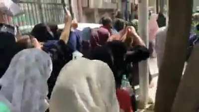 Taliban trying to calm down a crowd chanting "death to Pakistan, long live the resistance" before they overwhelm a barricade