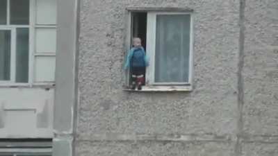 Russian kid hanging out the window for better view..