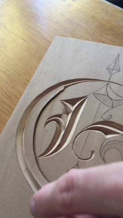 Calligraphy meets WoodCarving. Letter "G" for a commission. Written by Maya Telhami. Hand carved by myself in basswood using a Chip Carving knife.