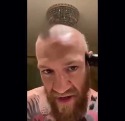 Conor McGregor shaves his head for a sick fan.
