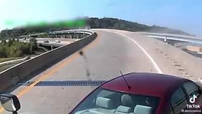 Idiot drives through a curve on his phone