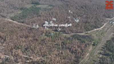 Russian positions in the Kharkiv region being hit by unguided rockets from helicopter and guided bombs from jet aviation. Recorded by Khorne Group drones, Published on July 15, 2024.