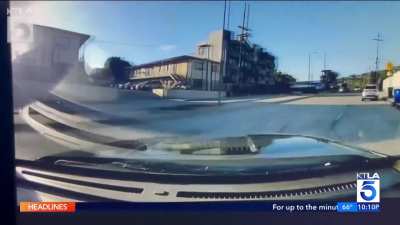LAPD Cop running on the street is hit by one of his colleagues in a cruiser and sent sliding down the road.