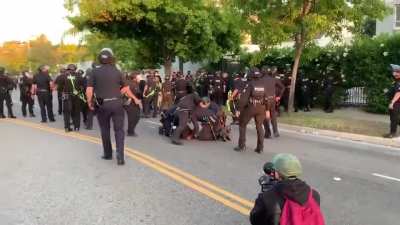Cop has his knee on a woman's neck even though there are 3 cops on her already. A different cop notices it and pulls him away.