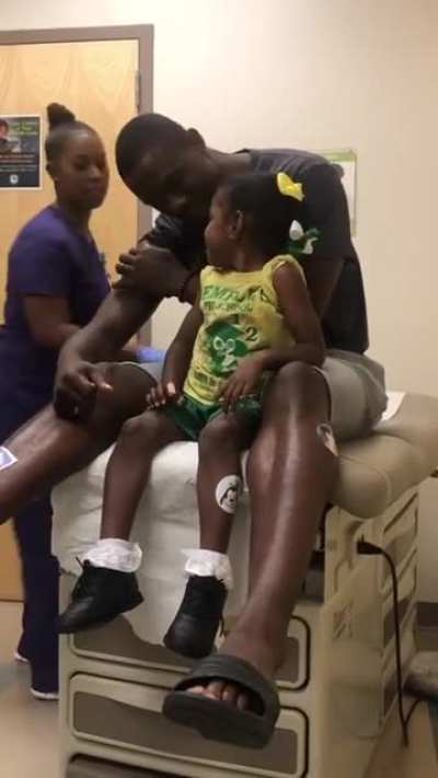 Dad gets (pretend) vaccinated first so daughter is less scared by needles.