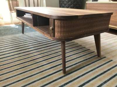I designed and built a mid century style coffee table with a cnc kerf cut &ldquo;tambour&rdquo; door. It was also my first time having custom brass hardware made for the feet, which turned out nice.