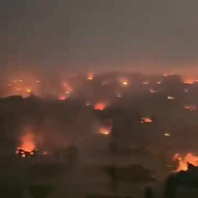 Gaza, tens of thousands of displaced, starving civilians searching for food amidst destruction.