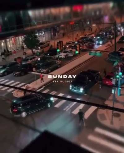 Unloads a gun through the sunroof to clear a crowd.
