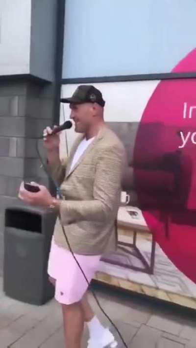Tyson Fury joins street performer and sings "Let Me Love You" while Billie Joe Saunders hypes them up.