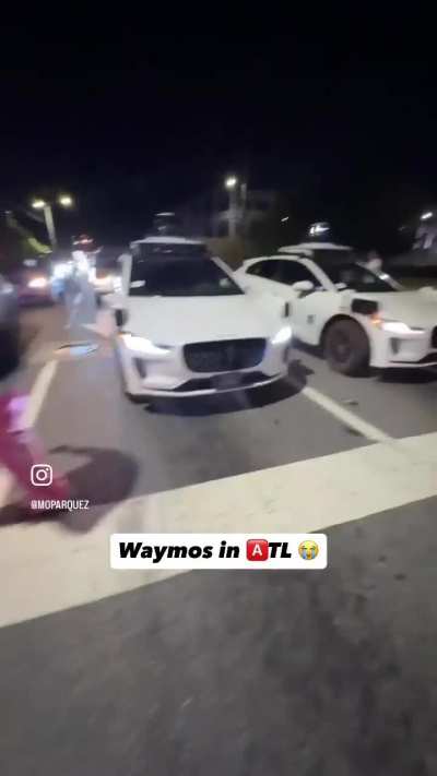 Three Waymos blocking lanes during flashing red lights in Atlanta