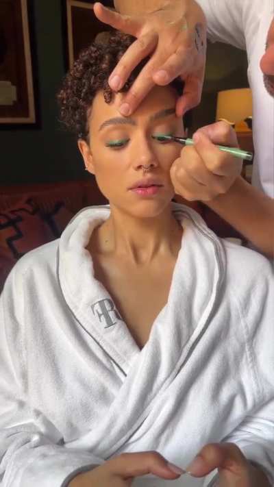 Getting her hair and makeup done 