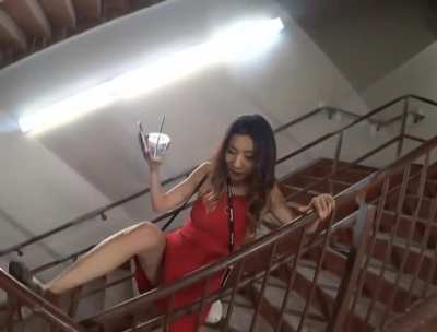Fuslie attempts to jump a railing in a dress