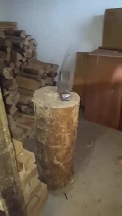 Chopping an old phone in half with an axe