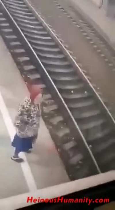 Babushka "falls" onto train tracks 