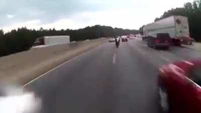 Bikes pass between cars in traffic