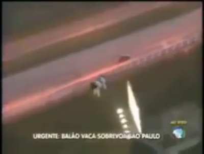 Translation: "Urgent! Balloon cow flies over S&atilde;o Paulo." Normal day