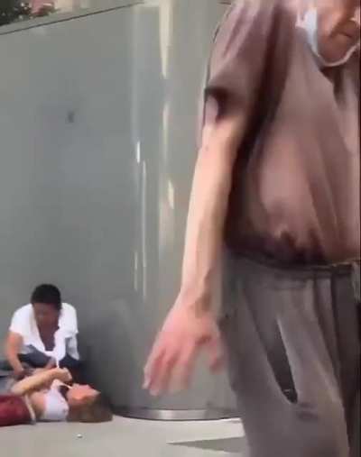 A woman is being mugged and this mentally ill homeless is dancing.
