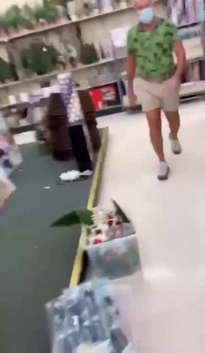 Man follows a woman throughout a store, demands she put her mask on.