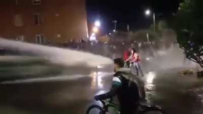 Guy in red confronting the pressure of water.