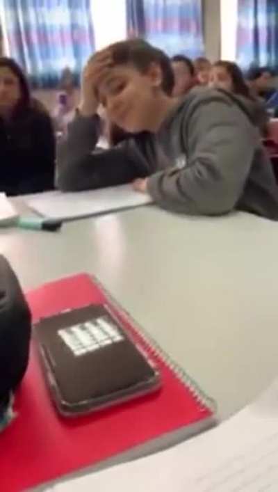 Kid receives permission from the teacher to eat a fruit during class.