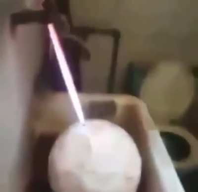 Filling a football with gas and lightning the escaping gas.