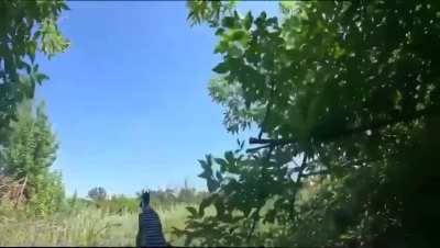 Russian servicemen see a drone approaching and shoot it with their rifles which causes an explosion
