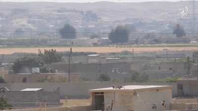 A ISIS fighter with an amputated leg fires his PKM at SDF positions in Raqqa, Syria.