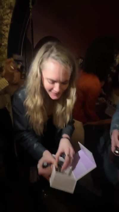 Cara getting a gift at a party | October 2025